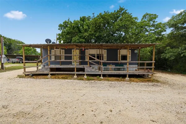 a view of a house with wooden fence