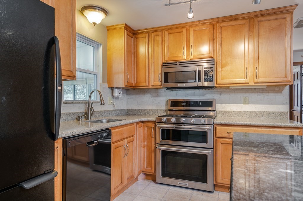 30 County Road Holyoke, MA 01040 - Photo 16 of 38 a kitchen with a sink stove and microwave