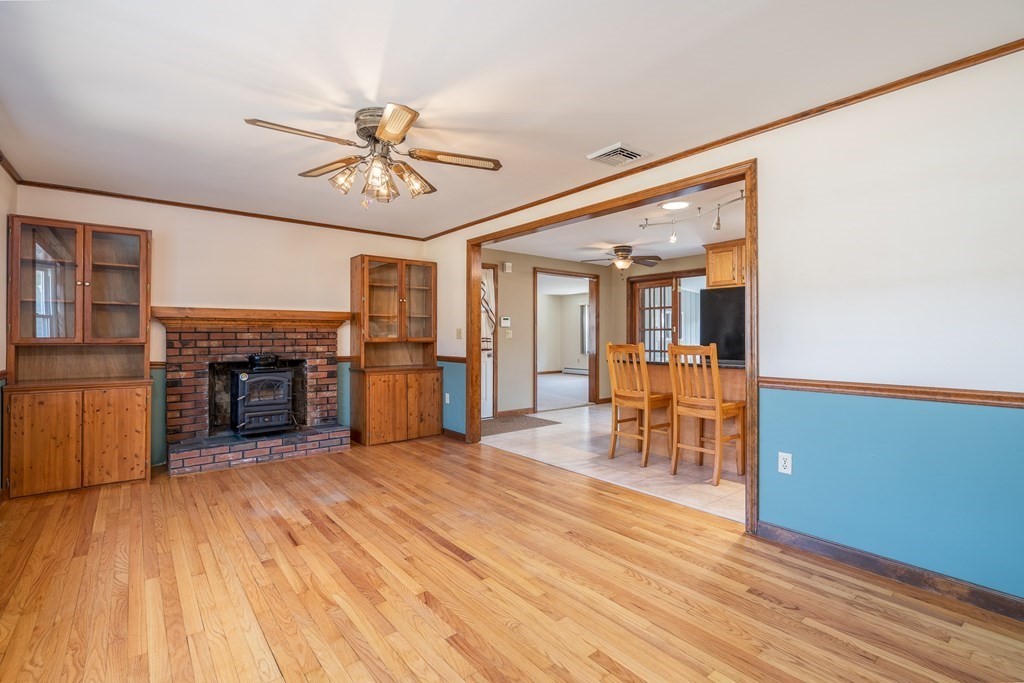 30 County Road Holyoke, MA 01040 - Photo 20 of 38 a view of a livingroom with furniture a fireplace wooden floor and a chandelier