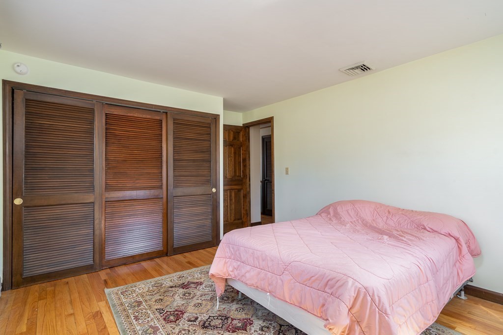 30 County Road Holyoke, MA 01040 - Photo 28 of 38 a bedroom with a bed and wooden floor