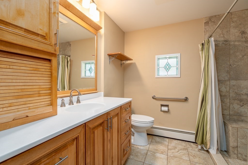 30 County Road Holyoke, MA 01040 - Photo 29 of 38 a bathroom with a sink a toilet and shower