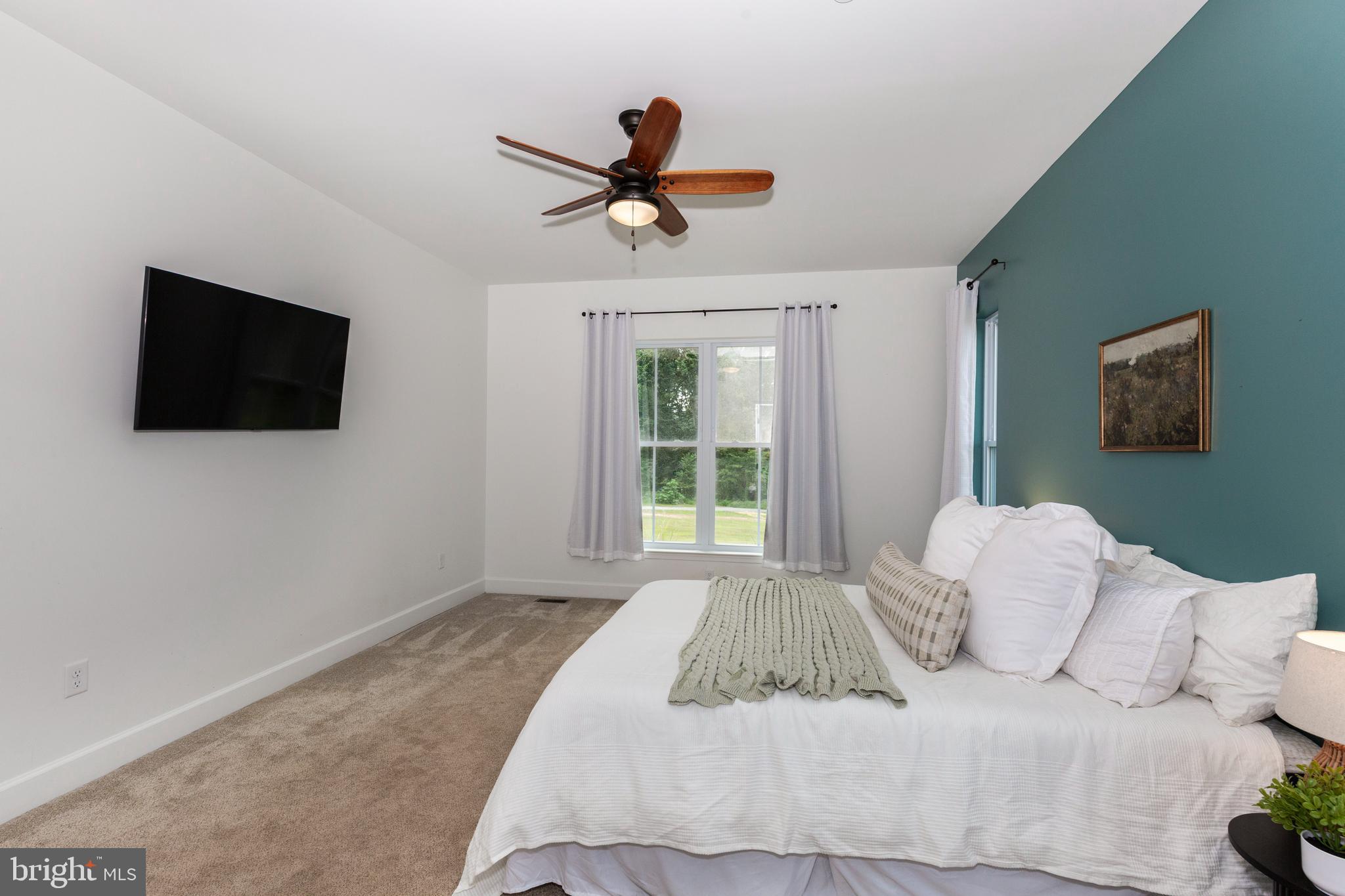 1865 Hughes Shop Road Westminster, MD 21158 - Photo 32 of 46 a bedroom with a bed and a flat screen tv