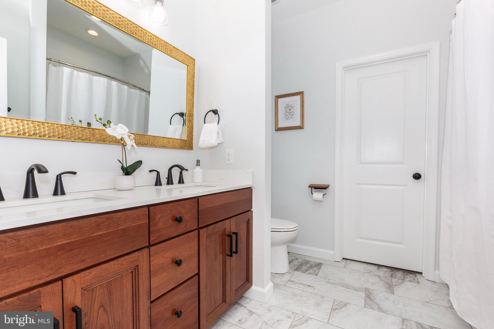 1865 Hughes Shop Road Westminster, MD 21158 - Photo 34 of 46 a spacious bathroom with a double vanity sink a mirror and a toilet