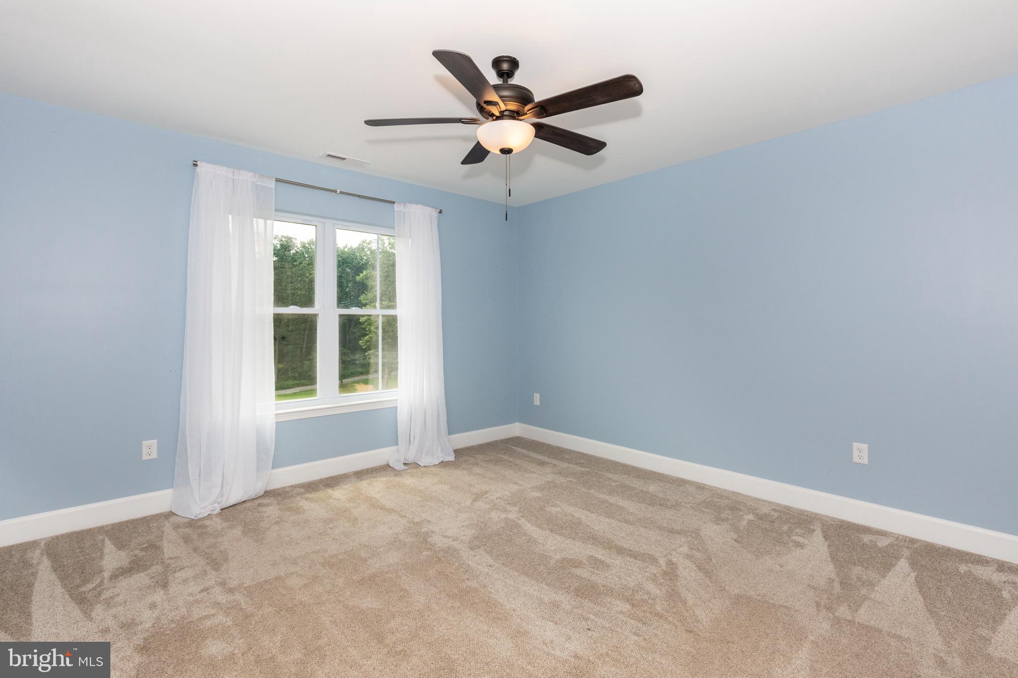 1865 Hughes Shop Road Westminster, MD 21158 - Photo 40 of 46 an empty room with ceiling fan and window