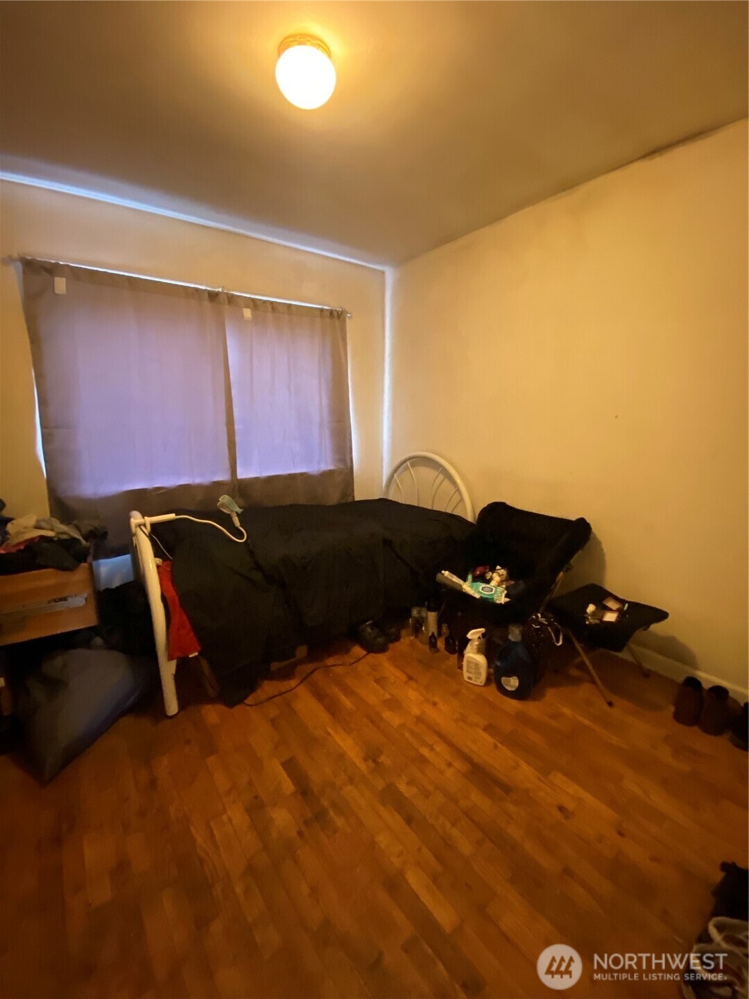 3625 15th Avenue South Seattle, WA 98144 - Photo 9 of 10 a bed room with a bed and a chair