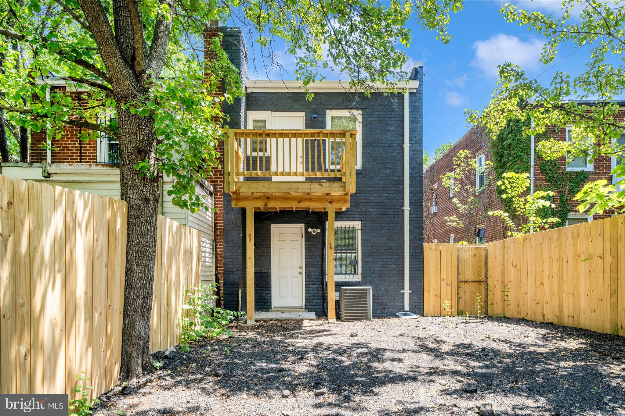 5027 Benning Road Southeast Washington, DC 20019 - Photo 50 of 57 a front view of a house with a yard