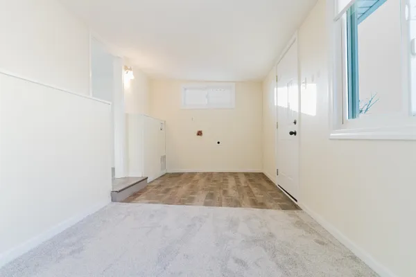 an empty room with windows and closet
