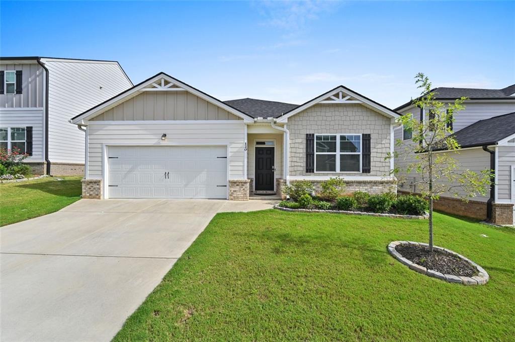a front view of a house with a yard and garage