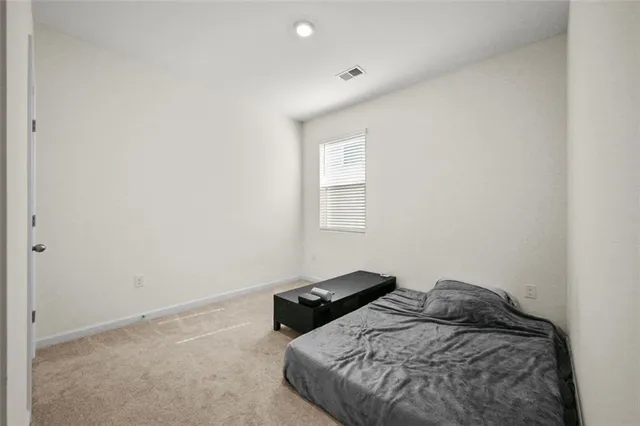 a bedroom with a bed and a ceiling fan