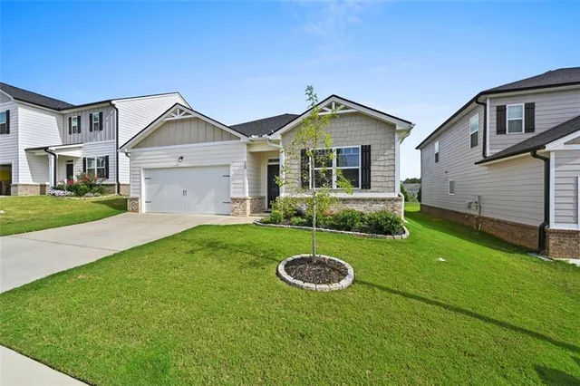 a front view of a house with yard