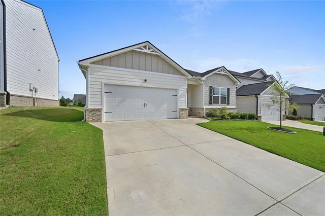 an aerial view of a house with a garden and lake view