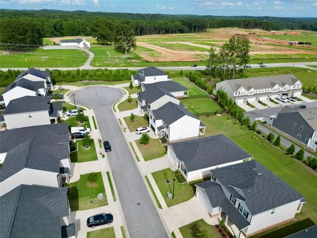 an aerial view of a house with garden space and street view