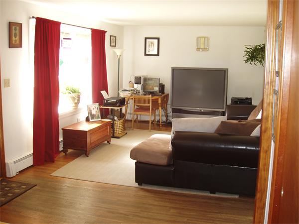 496 Harvard Road Lancaster, MA 01523 - Photo 7 of 12 a living room with furniture and a flat screen tv