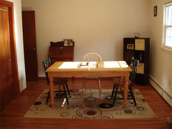 496 Harvard Road Lancaster, MA 01523 - Photo 8 of 12 a dining room with furniture and wooden floor