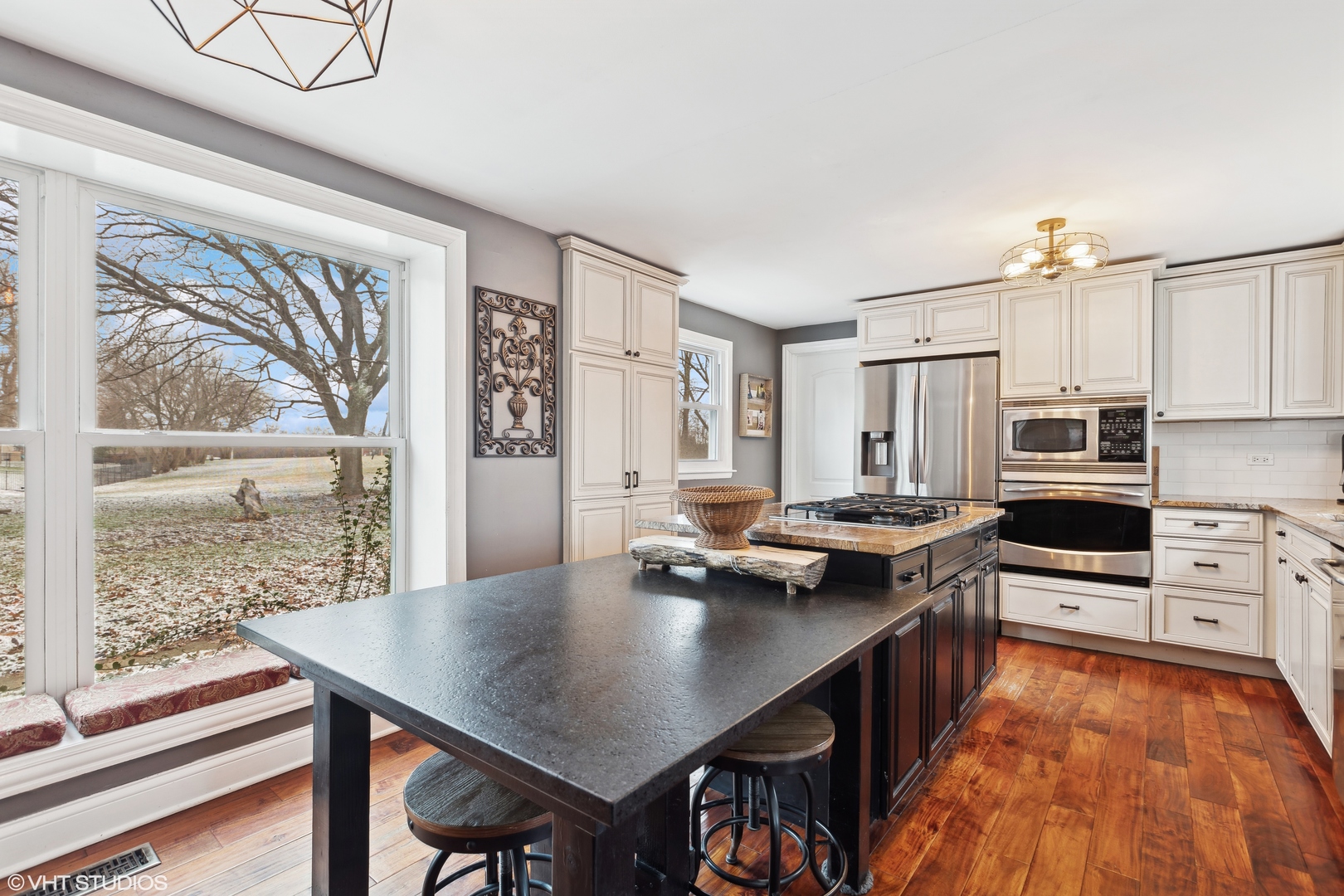 7102 Silver Lake Road Cary, IL 60013 - Photo 12 of 32 a kitchen with stainless steel appliances granite countertop a stove top oven a sink dishwasher and cabinets with wooden floor