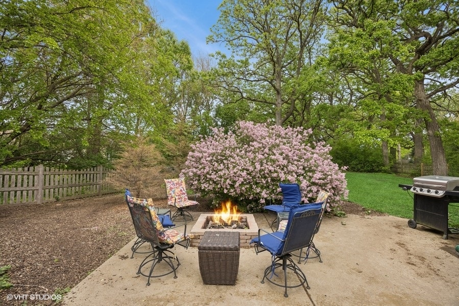 7102 Silver Lake Road Cary, IL 60013 - Photo 21 of 32 a view of a chairs and table in the back yard