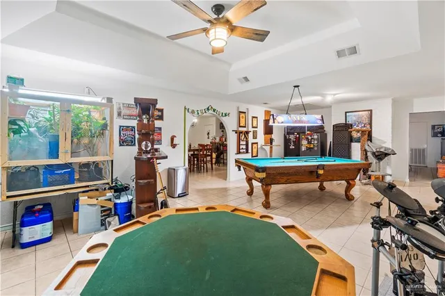 a room with furniture pool table and windows