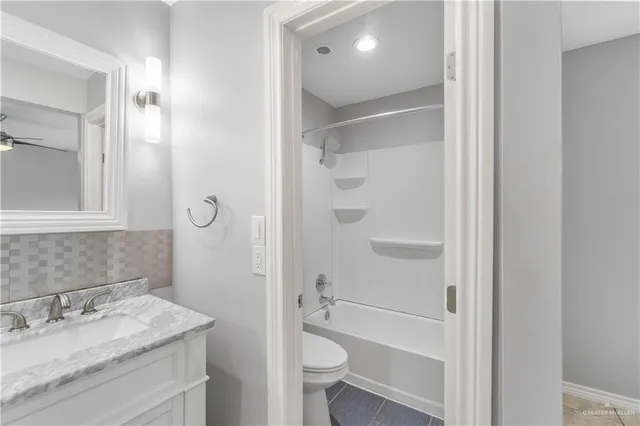 a view of a refrigerator in kitchen and an empty room