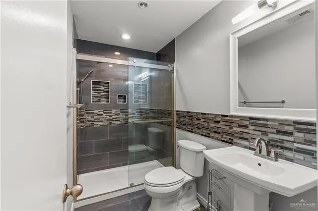 an empty room with ceiling fan and window