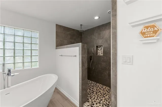 a bathroom with a granite countertop sink a toilet a mirror and shower