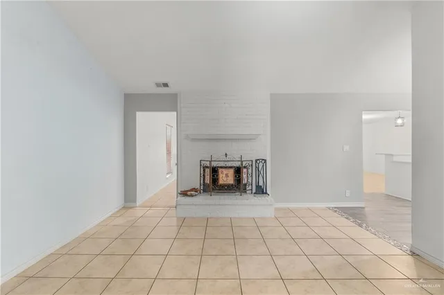 a view of an empty room and fire place