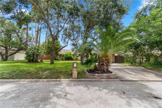 a front view of a house with a yard and a garage