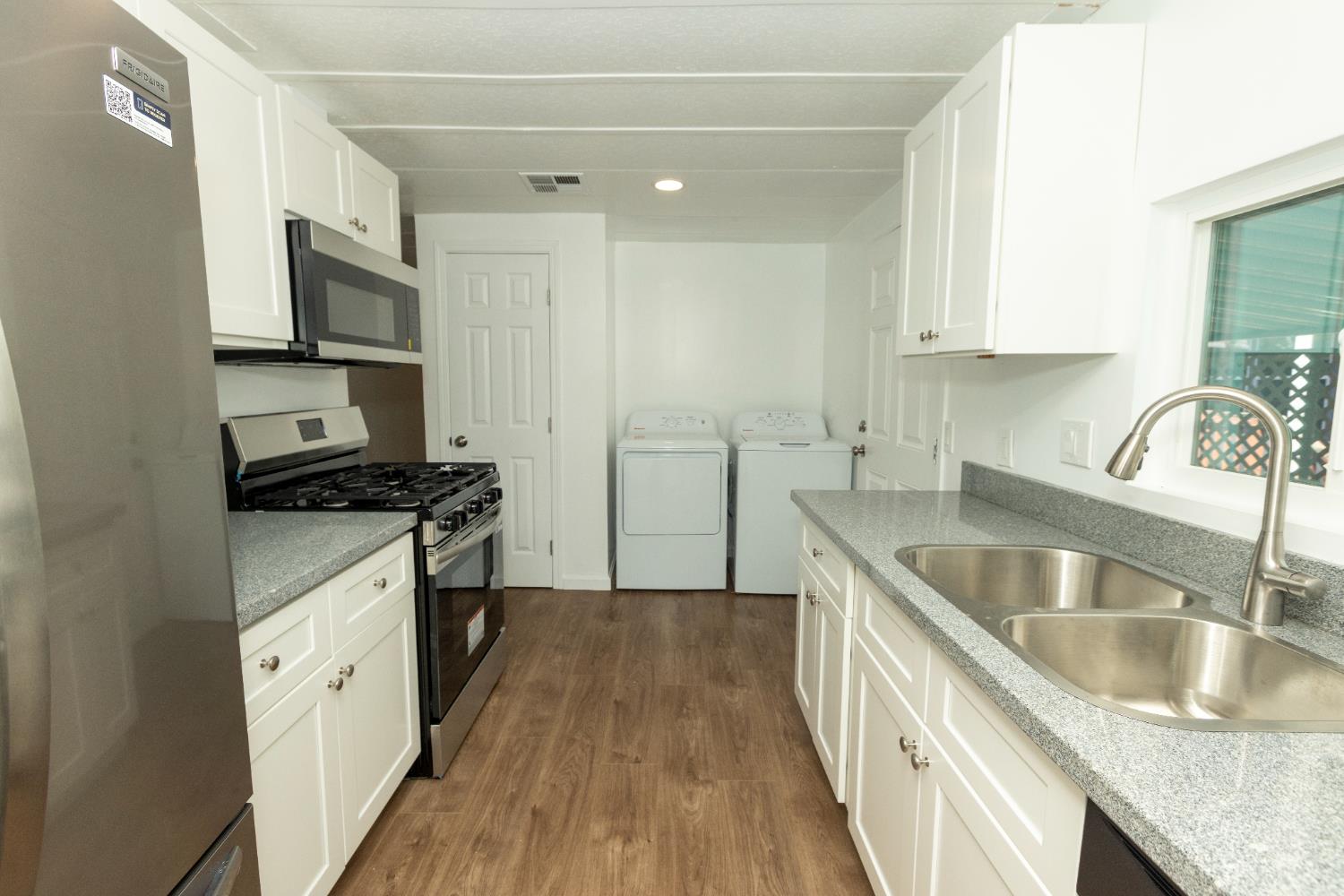 3901 Lake Road, Unit 151 West Sacramento, CA 95691 - Photo 11 of 18 a kitchen with granite countertop a sink stove and refrigerator