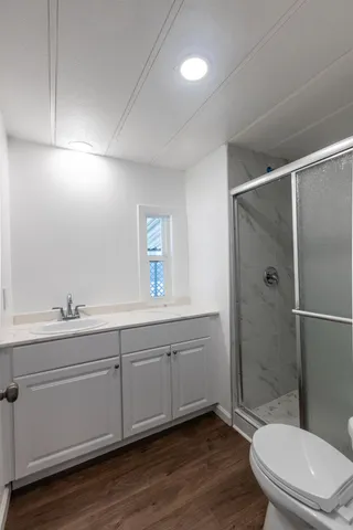 a bathroom with a toilet a sink and shower