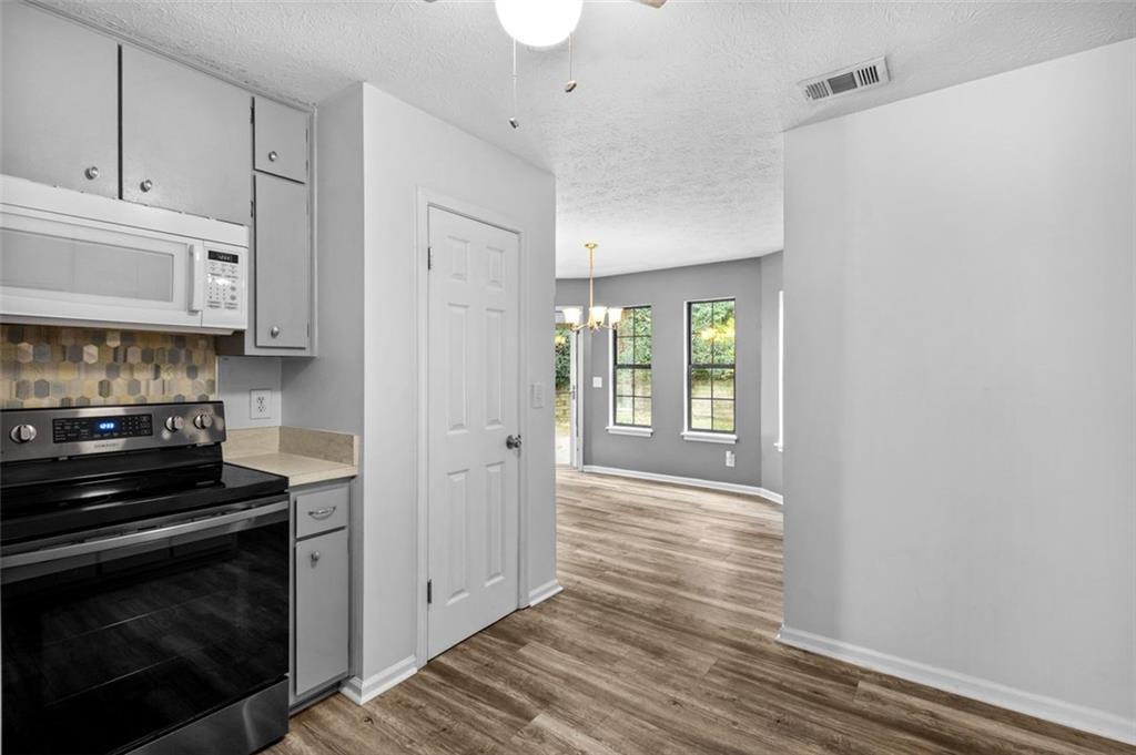 2888 Cardinal Trace Duluth, GA 30096 - Photo 13 of 51 a kitchen with granite countertop a stove and a refrigerator