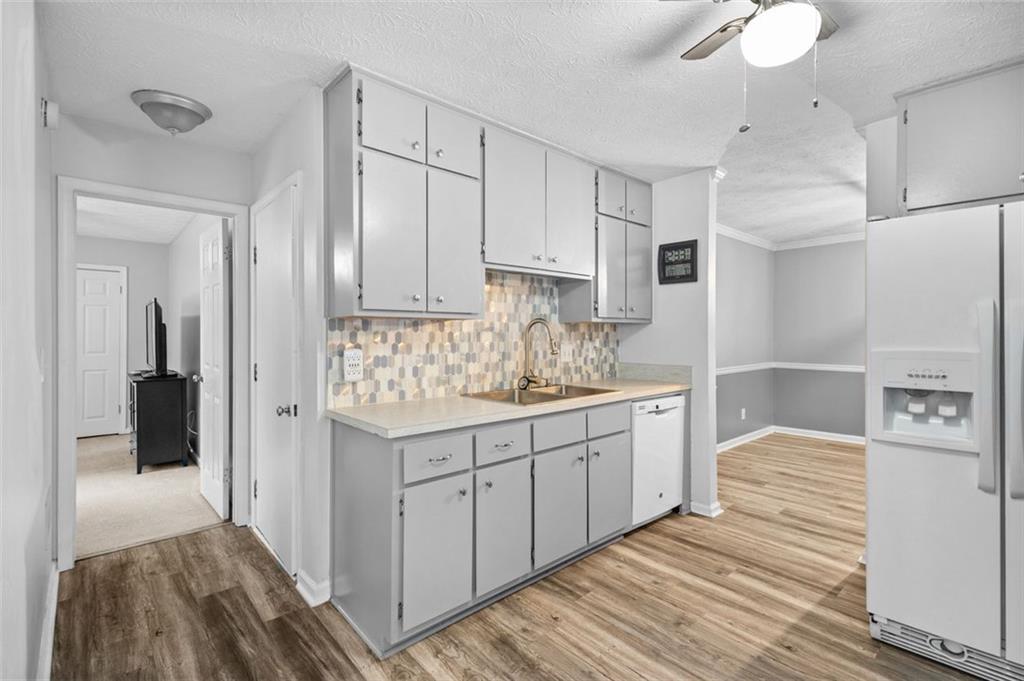 2888 Cardinal Trace Duluth, GA 30096 - Photo 15 of 51 a kitchen with granite countertop white cabinets and white appliances