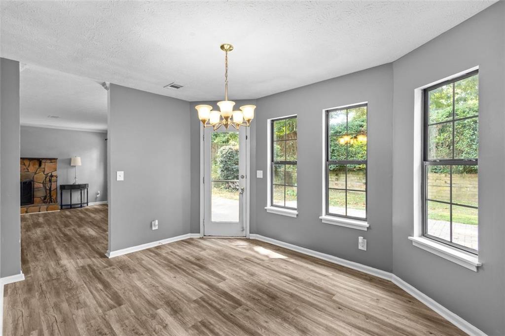 2888 Cardinal Trace Duluth, GA 30096 - Photo 18 of 51 a view of an empty room with wooden floor and a window