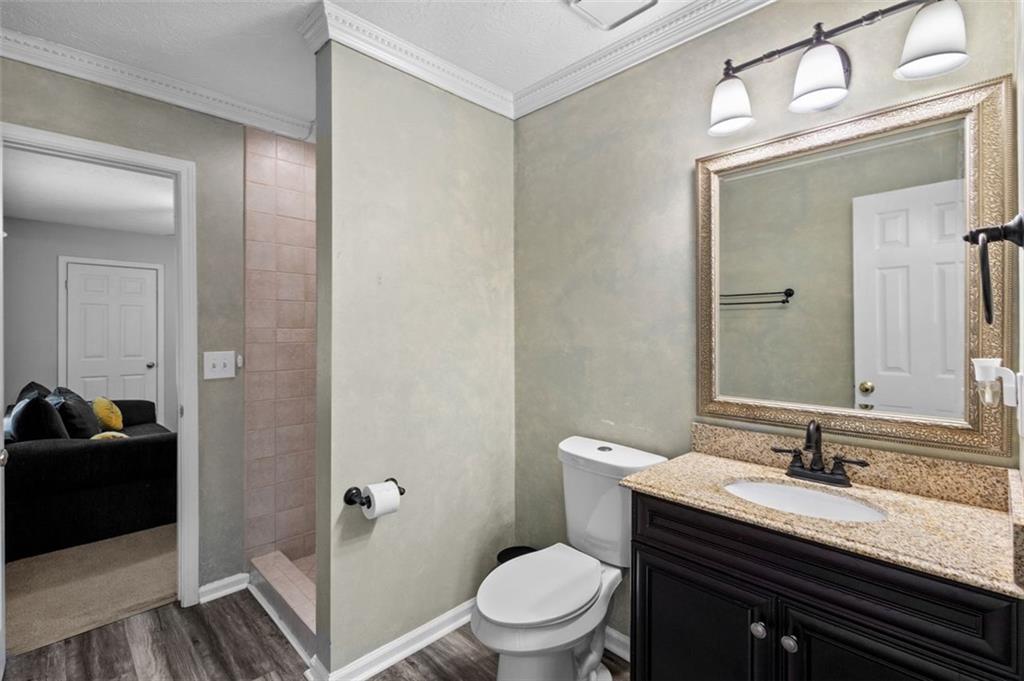 2888 Cardinal Trace Duluth, GA 30096 - Photo 20 of 51 a bathroom with a granite countertop sink toilet a mirror and shower