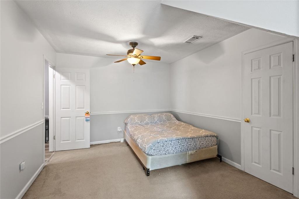 2888 Cardinal Trace Duluth, GA 30096 - Photo 25 of 51 a bedroom with a bed and ceiling fan