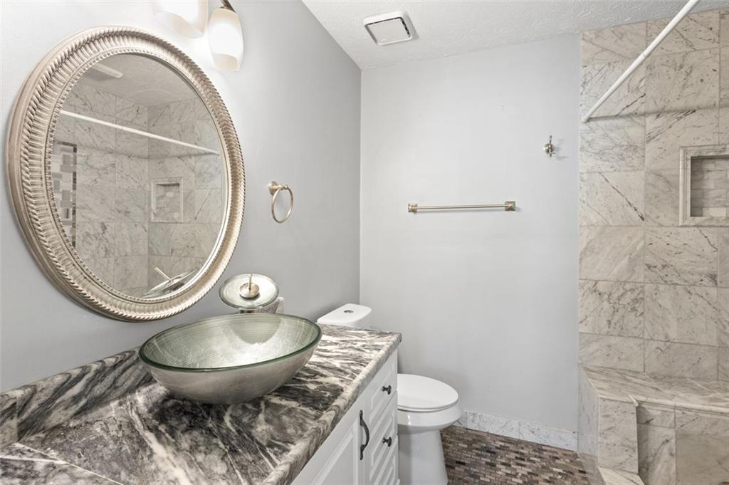 2888 Cardinal Trace Duluth, GA 30096 - Photo 27 of 51 a bathroom with a toilet a sink and a mirror