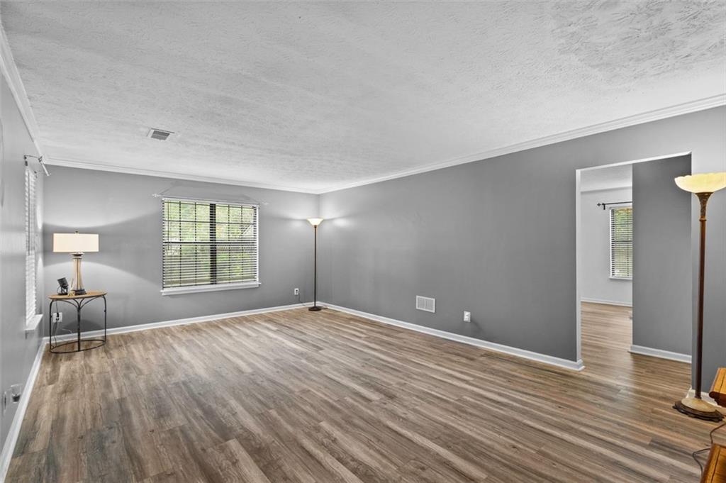 2888 Cardinal Trace Duluth, GA 30096 - Photo 7 of 51 a view of an empty room with wooden floor and a window