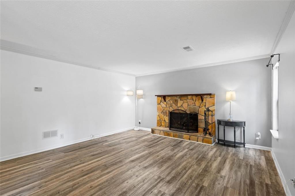 2888 Cardinal Trace Duluth, GA 30096 - Photo 9 of 51 a view of empty room with wooden floor fireplace and window