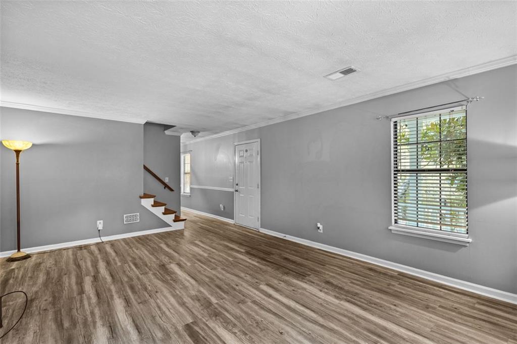 2888 Cardinal Trace Duluth, GA 30096 - Photo 10 of 51 a view of an empty room with wooden floor and a window