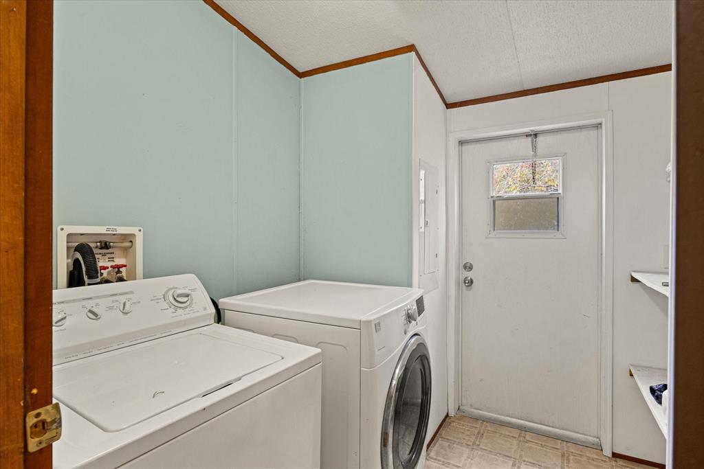 2903 Centaurus Way Granbury, TX 76048 - Photo 19 of 31 Laundry room with a textured ceiling, ornamental molding, washer and dryer, and light floors