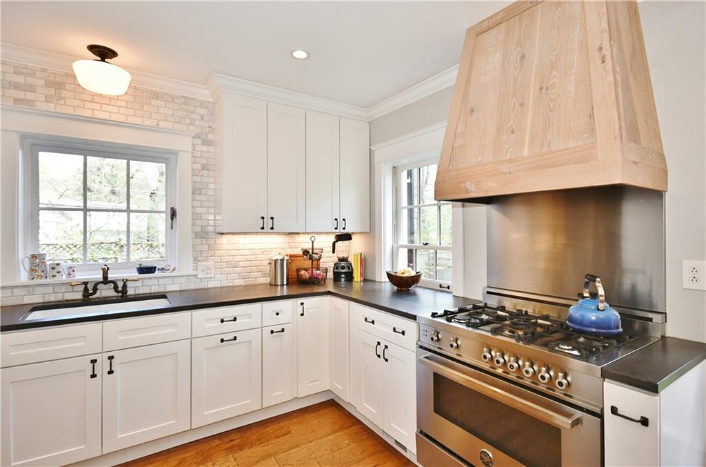 6623 Kinsman Road Pittsburgh, PA 15217 - Photo 11 of 25 a kitchen with granite countertop stainless steel appliances a sink cabinets and a window