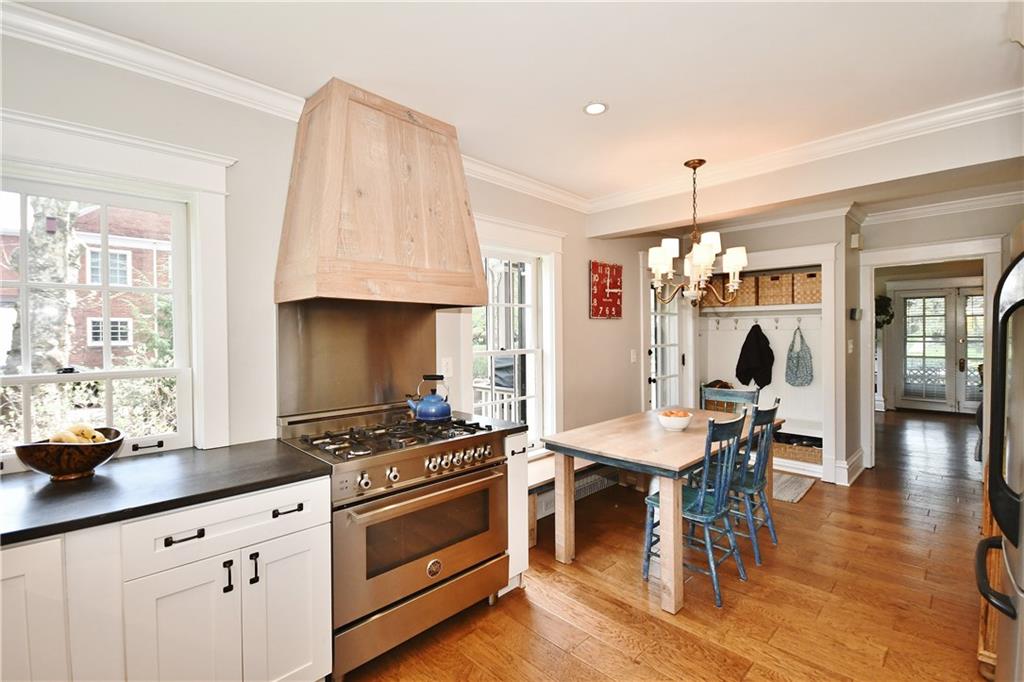 6623 Kinsman Road Pittsburgh, PA 15217 - Photo 12 of 25 a kitchen with stainless steel appliances a stove a sink a dining table and chairs