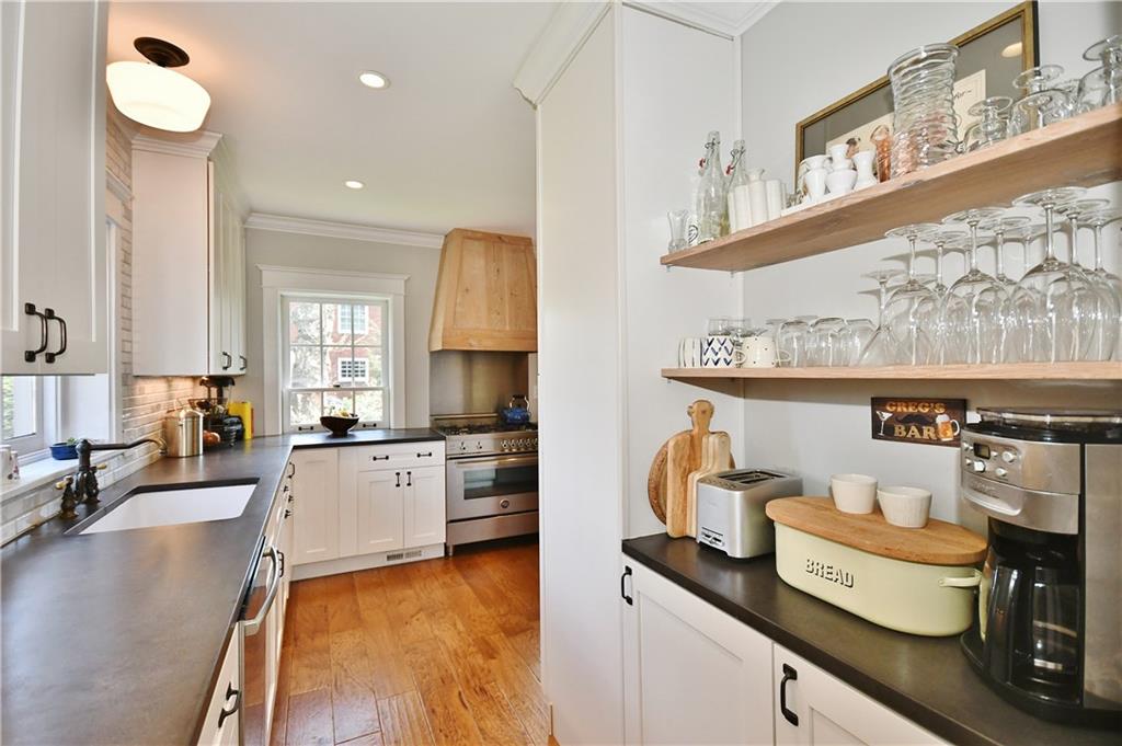 6623 Kinsman Road Pittsburgh, PA 15217 - Photo 13 of 25 a kitchen with stainless steel appliances granite countertop a stove a sink and a refrigerator