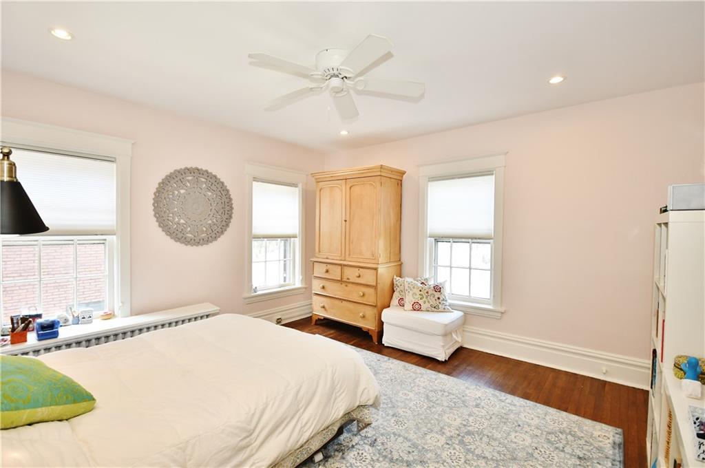 6623 Kinsman Road Pittsburgh, PA 15217 - Photo 14 of 25 a bedroom with a large bed and a chandelier