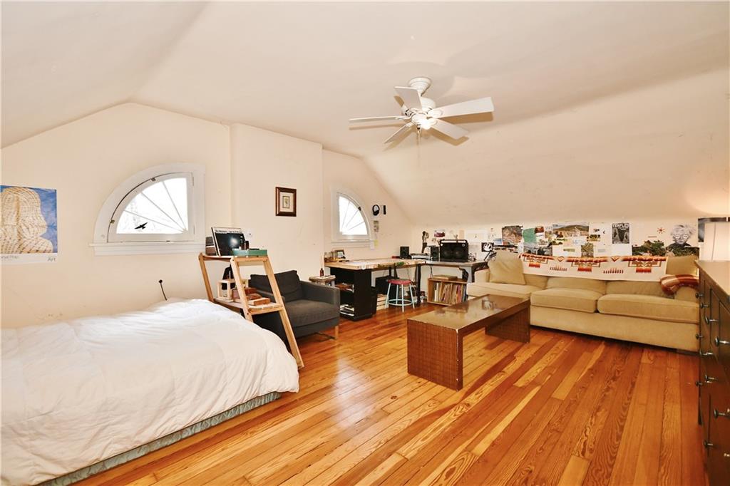 6623 Kinsman Road Pittsburgh, PA 15217 - Photo 16 of 25 a living room with furniture kitchen view and a wooden floor