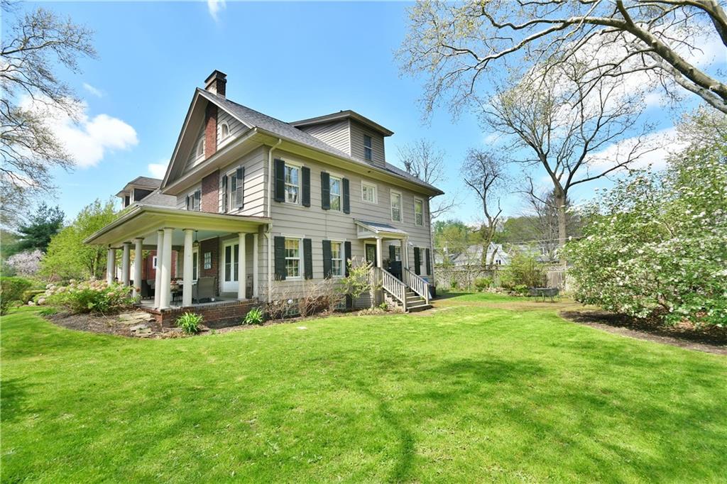 6623 Kinsman Road Pittsburgh, PA 15217 - Photo 2 of 25 a front view of a house with a yard table and chairs