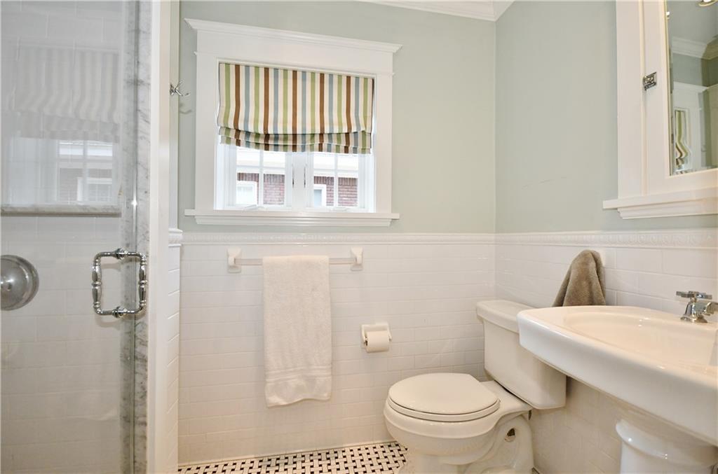 6623 Kinsman Road Pittsburgh, PA 15217 - Photo 23 of 25 a bathroom with a toilet a sink and a window