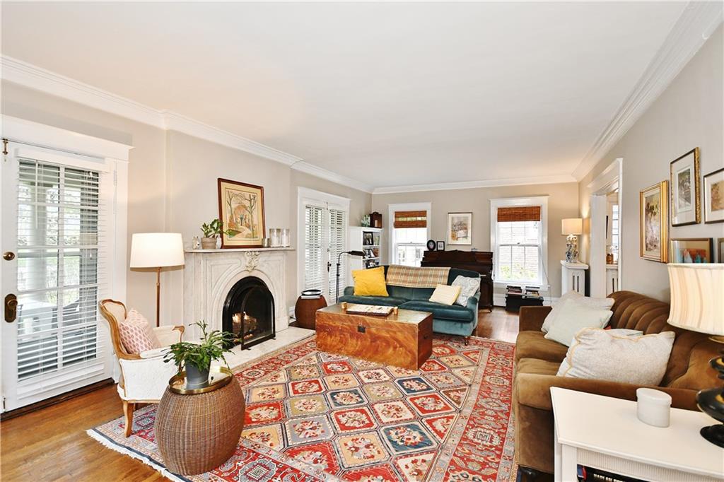 6623 Kinsman Road Pittsburgh, PA 15217 - Photo 7 of 25 a living room with furniture a fireplace and a window