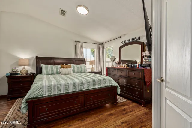 a bed sitting in a bedroom next to a lamp