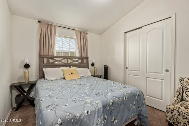 a bedroom with a large bed and a window