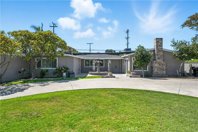 a view of a house with swimming pool and a yard