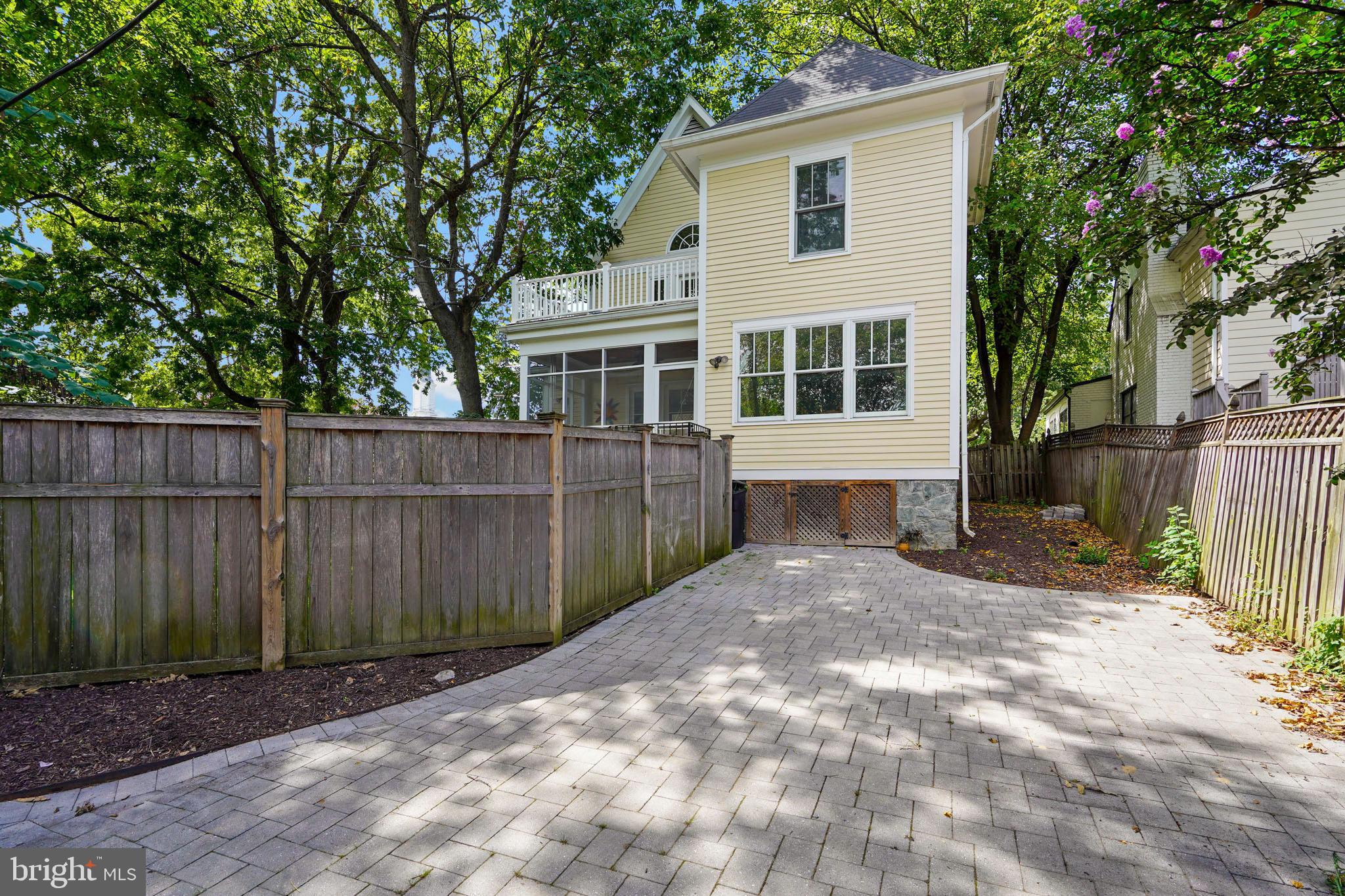 1503 Russell Road Alexandria, VA 22301 - Photo 29 of 31 a view of backyard with large trees and wooden fence